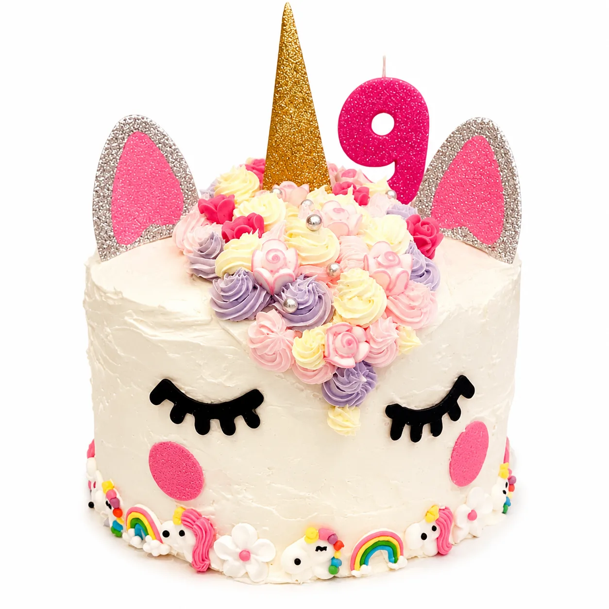White unicorn birthday cake with pastel rosettes rainbow trim and number 9 topper