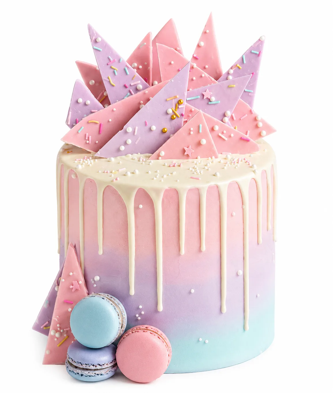 Pastel ombre drip cake with chocolate shards and macarons